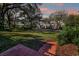 Serene front lawn view with brick steps, mature trees, and neighborhood street at 925 Northside Dr, Mount Dora, FL 32757