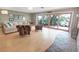 Living room with large sliding doors to deck, light wood floors, and eclectic mix of modern furniture at 925 Northside Dr, Mount Dora, FL 32757