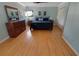 Comfortable bedroom with light blue walls, wood floors, and a large mirror above the dresser at 925 Northside Dr, Mount Dora, FL 32757