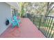 Outdoor patio with metal railing and blue chairs overlooks the surrounding greenery at 925 Northside Dr, Mount Dora, FL 32757