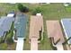 Aerial view of a well-maintained single-story home with a long driveway and lush landscaping in a quiet neighborhood at 9481 Sw 93Rd Loop, Ocala, FL 34481