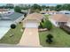 Charming one-story home featuring a well-manicured lawn, inviting driveway, and attached garage at 9481 Sw 93Rd Loop, Ocala, FL 34481