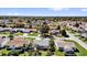 Aerial view of a residential neighborhood featuring neat landscaping, diverse homes, and mature shade trees at 9511 Se 168Th Elderberry Pl, The Villages, FL 32162