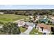 Neighborhood aerial view with lush trees and landscaped lawns surrounding cozy homes with various roof styles at 9511 Se 168Th Elderberry Pl, The Villages, FL 32162