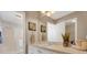 Well-lit bathroom featuring a shower and vanity with decorative items and a large mirror reflecting the bright space at 9511 Se 168Th Elderberry Pl, The Villages, FL 32162