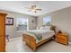 Cozy bedroom with neutral walls, bright windows, ceiling fan, and light wood furniture at 9511 Se 168Th Elderberry Pl, The Villages, FL 32162