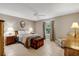 Bedroom featuring neutral paint, tile flooring, ceiling fan, and plenty of natural light at 9511 Se 168Th Elderberry Pl, The Villages, FL 32162