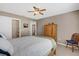 Bedroom features neutral walls, ceiling fan, closet, and light-colored furniture at 9511 Se 168Th Elderberry Pl, The Villages, FL 32162