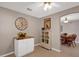 Charming dining area with a cabinet, decorative clock, and a view into the dining room at 9511 Se 168Th Elderberry Pl, The Villages, FL 32162