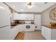 Bright kitchen with white cabinets, granite countertops, stainless appliances, and a tile floor at 9511 Se 168Th Elderberry Pl, The Villages, FL 32162