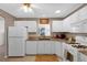 Well-lit kitchen showcasing white cabinets, granite counters, and modern appliances at 9511 Se 168Th Elderberry Pl, The Villages, FL 32162