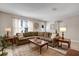 Comfortable living room showcasing tile floors, a decorative rug, and an inviting, over-sized sectional sofa at 9511 Se 168Th Elderberry Pl, The Villages, FL 32162