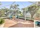 Enclosed patio featuring a dining table and a view of the well-maintained backyard at 9511 Se 168Th Elderberry Pl, The Villages, FL 32162