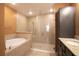 Bright bathroom featuring a soaking tub, a glass-enclosed shower, and a vanity with granite countertops at 1041 Bradford Ridge Dr, Leesburg, FL 34748