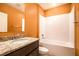 Bathroom featuring a granite countertop vanity and a white tub at 1041 Bradford Ridge Dr, Leesburg, FL 34748