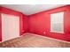 Bedroom featuring red walls, neutral carpet, and a window at 1041 Bradford Ridge Dr, Leesburg, FL 34748