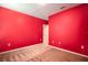 Bedroom featuring red walls and neutral carpet at 1041 Bradford Ridge Dr, Leesburg, FL 34748