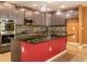 Contemporary kitchen featuring dark wood cabinets, pendant lighting, and a center island with a sink at 1041 Bradford Ridge Dr, Leesburg, FL 34748