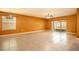 Expansive living room boasts neutral tile flooring and sliding glass doors to the outdoors at 1041 Bradford Ridge Dr, Leesburg, FL 34748