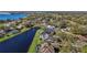 Aerial view of lakeside homes with backyard pools, screened patios, and lush greenery at 1075 Ceasars Ct, Mount Dora, FL 32757