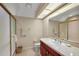 Bathroom featuring a long mirror and a glass shower with gold trim at 1075 Ceasars Ct, Mount Dora, FL 32757