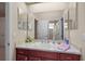 Bright bathroom with a long mirror, double doors, and great vanity space at 1075 Ceasars Ct, Mount Dora, FL 32757