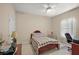 Bedroom with a ceiling fan, a window with blinds, and desk area at 1075 Ceasars Ct, Mount Dora, FL 32757