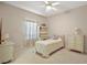 Bedroom boasting large window with blinds and an accent desk with shelving at 1075 Ceasars Ct, Mount Dora, FL 32757