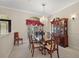 Elegant dining room featuring chandelier, china cabinet, and large window at 1075 Ceasars Ct, Mount Dora, FL 32757