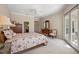 Serene main bedroom with large windows, walk-in closet, and private access to an outdoor balcony at 1075 Ceasars Ct, Mount Dora, FL 32757