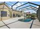 Backyard pool and patio with a screened enclosure, providing a private and relaxing outdoor space at 1075 Ceasars Ct, Mount Dora, FL 32757