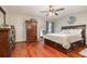 Bedroom with wood flooring, ceiling fan, and a bed with storage drawers underneath at 11415 Palmetto Dr, Tavares, FL 32778