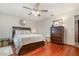 Bedroom featuring wood flooring, ceiling fan, and a bed with storage underneath at 11415 Palmetto Dr, Tavares, FL 32778