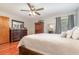 Spacious main bedroom featuring wood floors, neutral walls, ceiling fan and ample closet space at 11415 Palmetto Dr, Tavares, FL 32778