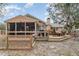 Home featuring a rear porch, deck, and backyard, creating a serene and private outdoor space at 11415 Palmetto Dr, Tavares, FL 32778