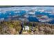 Expansive aerial view of the waterfront property showcasing the home's idyllic setting at 12117 Cypress Ln, Clermont, FL 34711