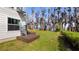 Spacious backyard with lush lawn and serene water views at 12117 Cypress Ln, Clermont, FL 34711