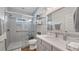 Bathroom featuring a glass-enclosed shower, gray vanity, and modern fixtures at 12117 Cypress Ln, Clermont, FL 34711