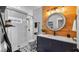 Stylish bathroom with a wood accent wall, glass shower, and modern vanity at 12117 Cypress Ln, Clermont, FL 34711