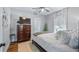 Bedroom with a queen bed, wood floors, a dresser, and natural light from the window at 12117 Cypress Ln, Clermont, FL 34711