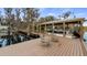 Beautiful dock with boat lift, Adirondack chairs and lakeside views at 12117 Cypress Ln, Clermont, FL 34711