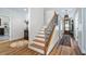 Bright entryway with wood floors, white walls, staircase and decorative accents leading into a spacious home at 12117 Cypress Ln, Clermont, FL 34711