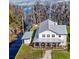 Aerial view showcases a lovely two story home with a spacious lawn with a nearby lake view at 12117 Cypress Ln, Clermont, FL 34711