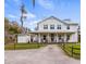 Charming two-story home with a welcoming front porch and well-manicured landscaping, inviting comfort and style at 12117 Cypress Ln, Clermont, FL 34711