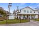 Charming two-story white farmhouse with a welcoming front porch and detached shed at 12117 Cypress Ln, Clermont, FL 34711