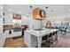Modern kitchen with large island and seating, adjacent to dining area and lake view at 12117 Cypress Ln, Clermont, FL 34711