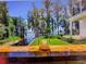 Scenic lake view from the deck with Spanish Moss Trees and lush green lawn at 12117 Cypress Ln, Clermont, FL 34711