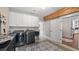 Bright laundry room features cabinetry, modern washer and dryer with decorative flooring at 12117 Cypress Ln, Clermont, FL 34711