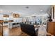 Open-concept living area showcases kitchen, fireplace, lake views, and comfortable leather seating at 12117 Cypress Ln, Clermont, FL 34711