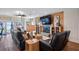Inviting living room features a stone fireplace, wood accent walls, comfortable seating, and lake views at 12117 Cypress Ln, Clermont, FL 34711